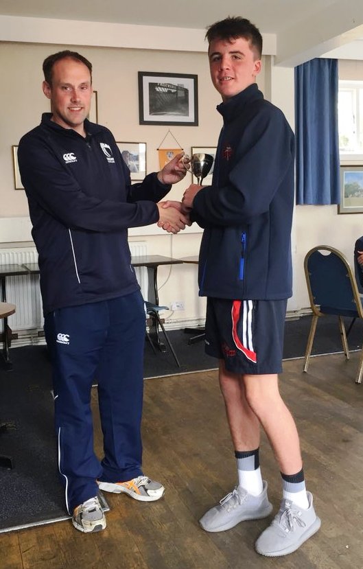 Belfast captain Rory Ellerby receives the Charlie Beverland Memorial Cup from Tim Hart Cricket Scotland's Western Region Development Manager
